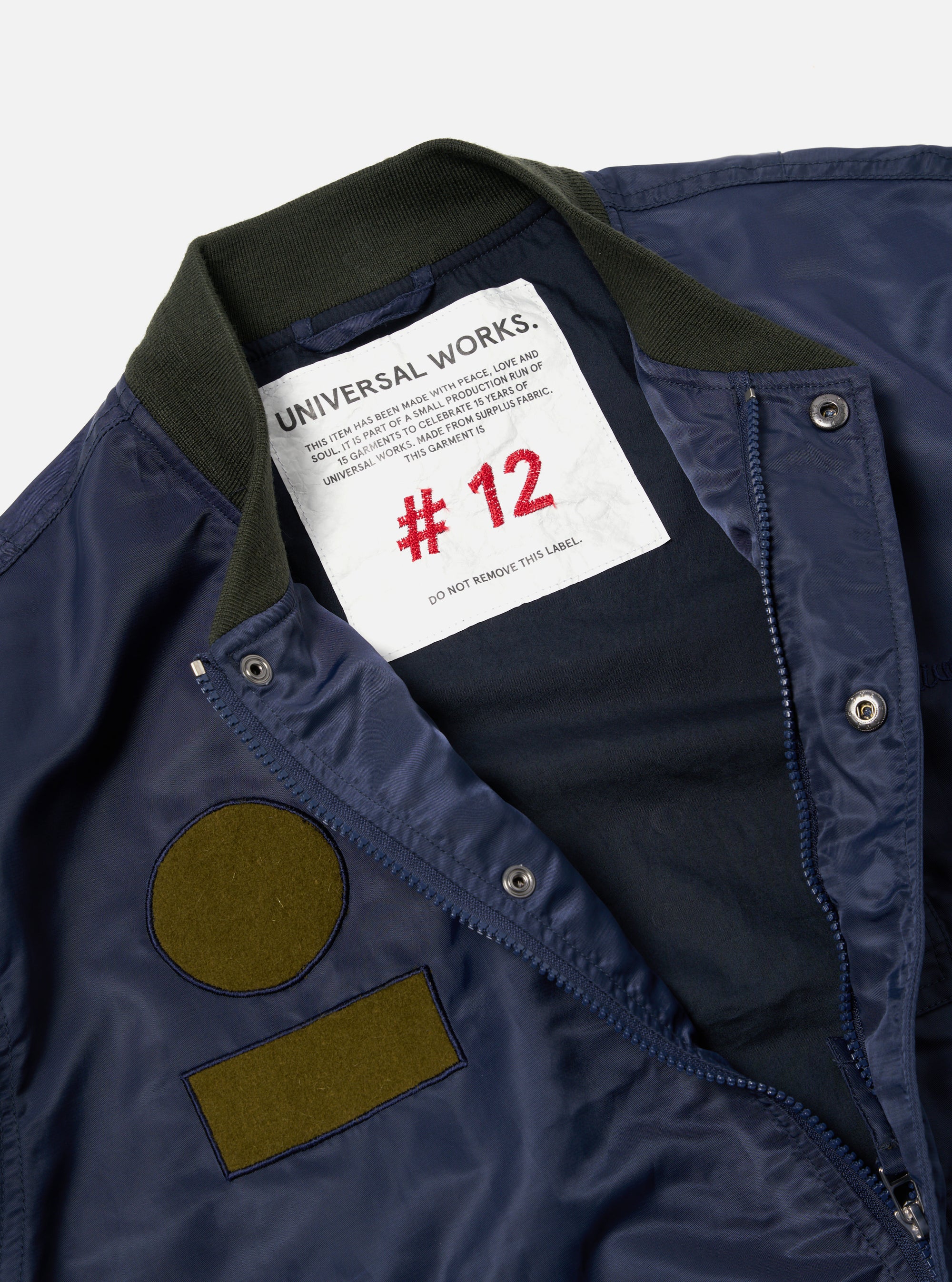 Universal Works Badge Bomber in Olive/Navy Flight Nylon