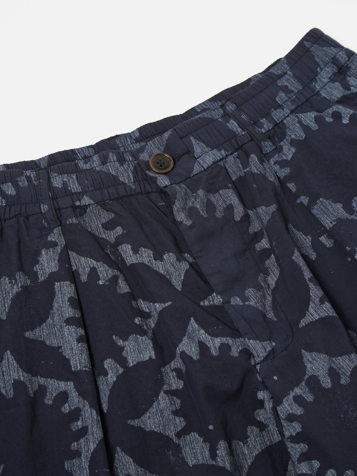 Universal Works Pleated Track Short in Navy Over Dyed Sun Print