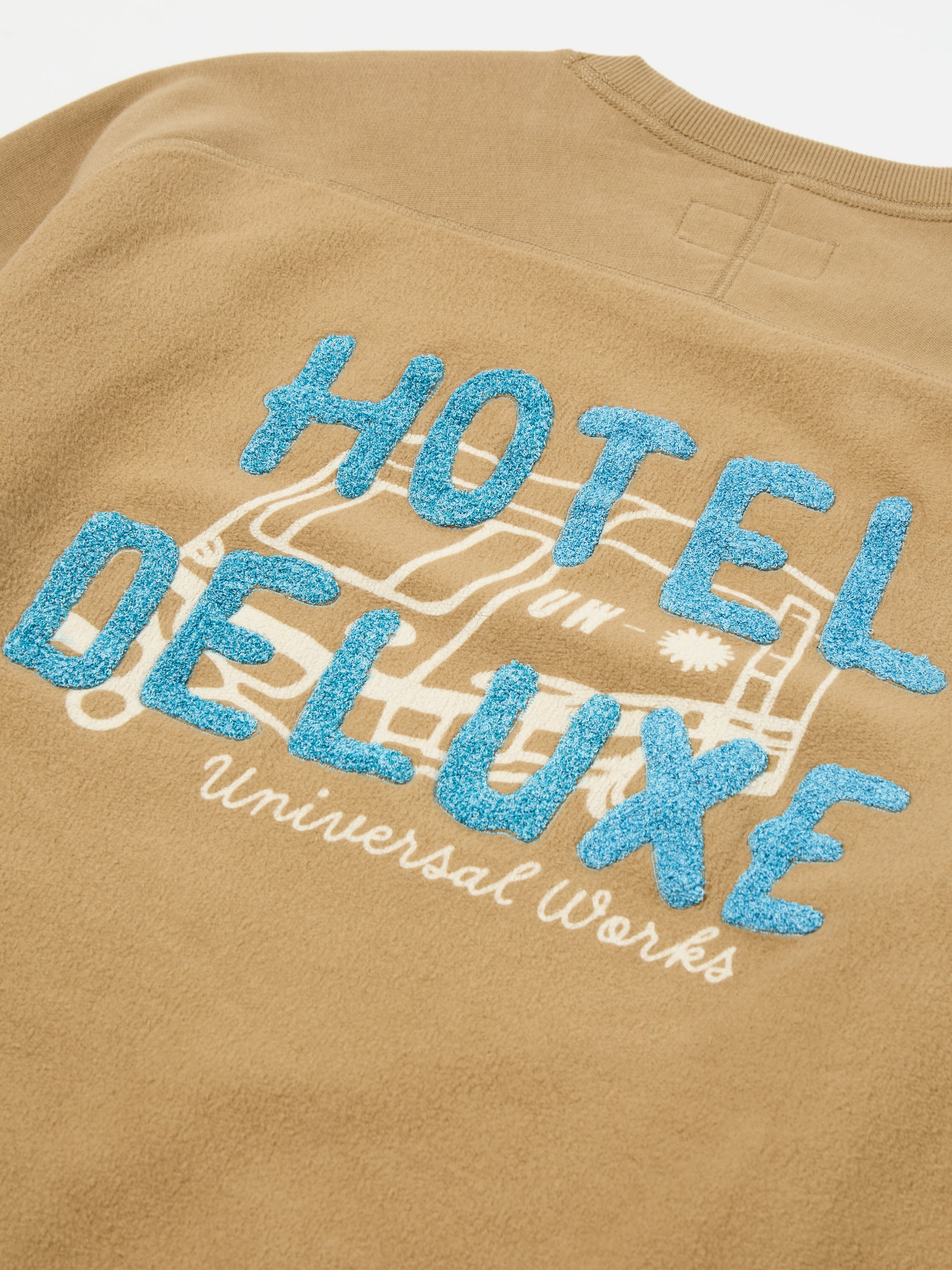 Universal Works Crew Sweat in Sand 'Hotel Deluxe' Embroidered Brush Back